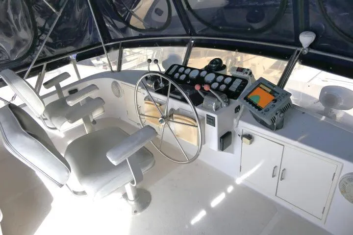 Slide: The Image of Cockpit of 1986 Ocean Alexander 39 Sedan with steering wheel and navigation equipment. - 46