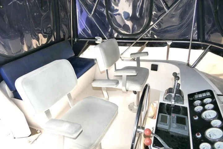 Slide: The Image of 1986 Ocean Alexander 39 Sedan yacht cockpit with seating and control panel. - 47