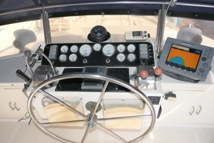 Slide: The Image of Helm of 1986 Ocean Alexander 39 Sedan with gauges and navigation equipment. - 48