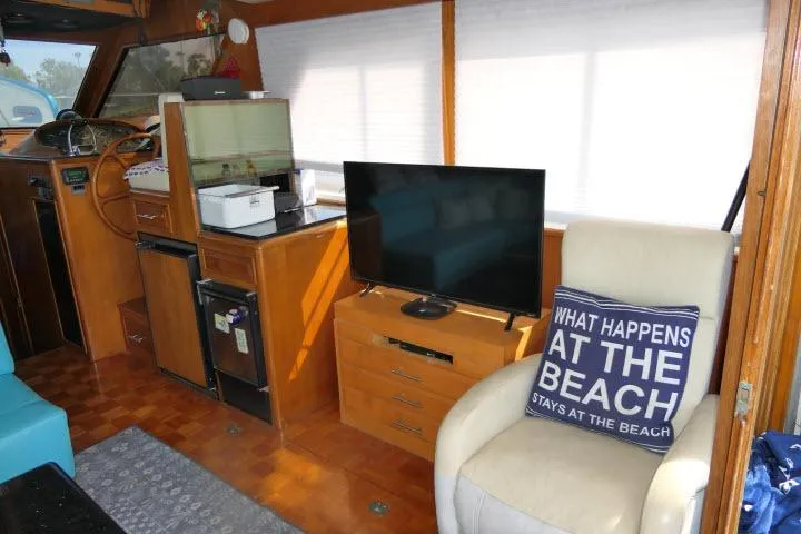 Slide: The Image of Interior of 1986 Ocean Alexander 39 Sedan with TV, chair, and nautical decor. - 5