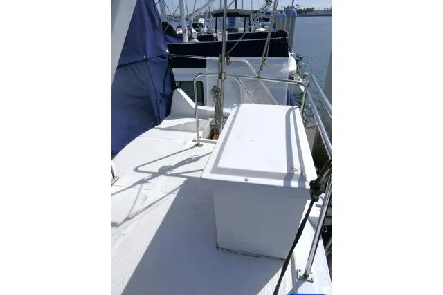 Slide: The Image of 1986 Ocean Alexander 39 Sedan deck with storage box, docked at marina. - 51