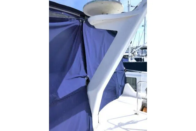 Slide: The Image of 1986 Ocean Alexander 39 Sedan with blue canvas cover and radar arch. - 52