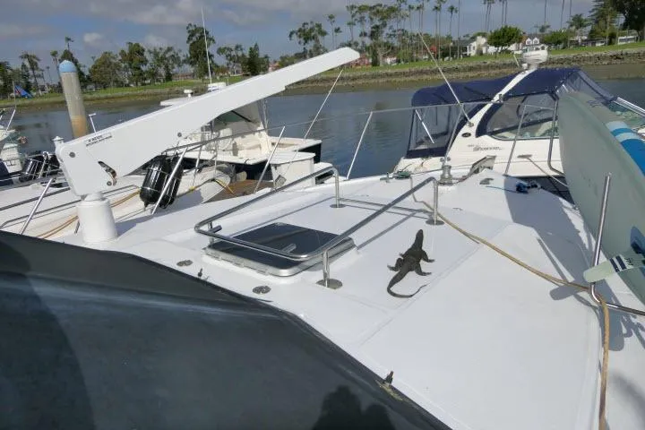 Slide: The Image of 1986 Ocean Alexander 39 Sedan yacht docked, featuring spacious deck and sleek design. - 54