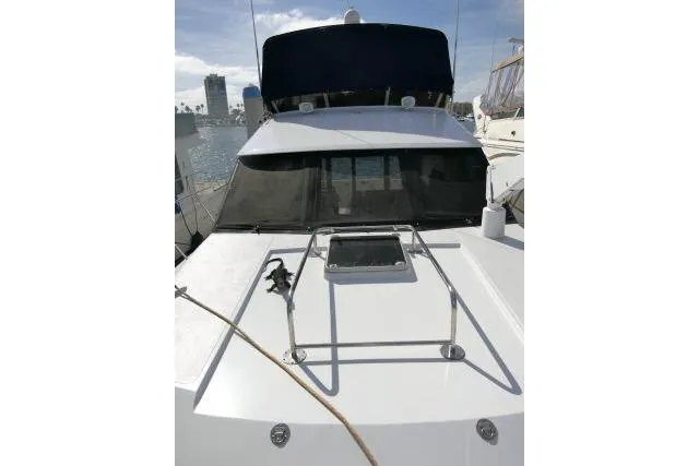 Slide: The Image of 1986 Ocean Alexander 39 Sedan yacht with sleek white deck and black canopy. - 55