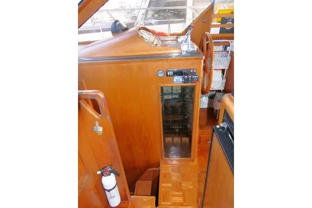 Slide: The Image of 1986 Ocean Alexander 39 Sedan interior with wooden helm and control panel. - 6