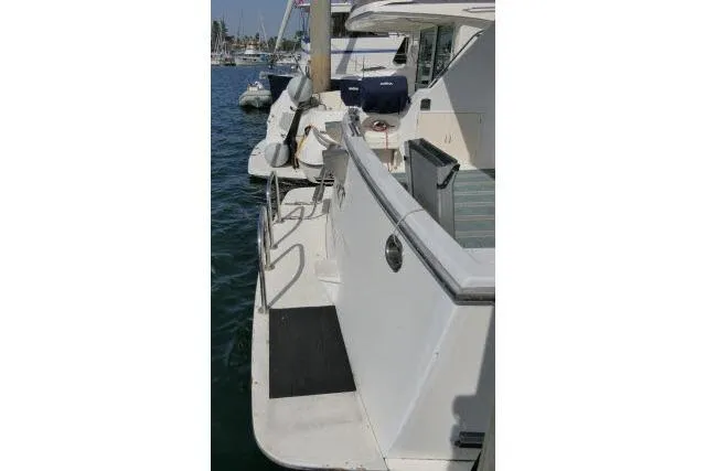 Slide: The Image of 1986 Ocean Alexander 39 Sedan yacht docked, showing deck and railing details. - 60