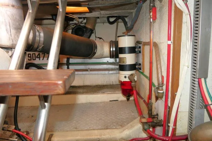 Slide: The Image of Engine room of 1986 Ocean Alexander 39 Sedan with visible piping and equipment. - 64