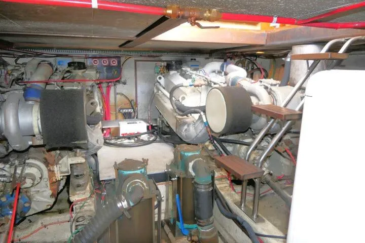 Slide: The Image of Engine room of 1986 Ocean Alexander 39 Sedan with visible machinery and piping. - 65