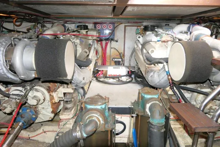 Slide: The Image of Engine room of 1986 Ocean Alexander 39 Sedan yacht, showcasing dual engines and mechanical components. - 67