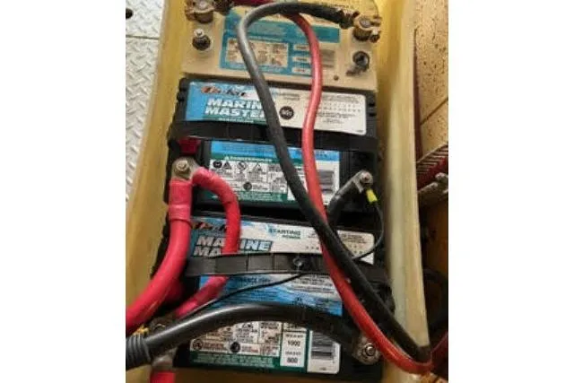 Slide: The Image of Marine batteries in 1986 Ocean Alexander 39 Sedan, connected with red and black cables. - 75
