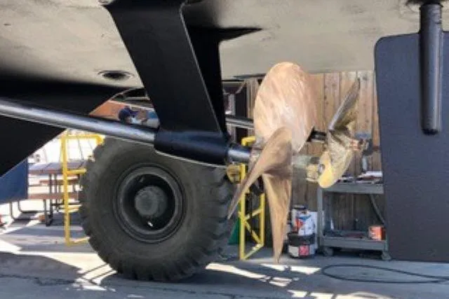 Slide: The Image of Propeller of 1986 Ocean Alexander 39 Sedan in a maintenance area. - 76