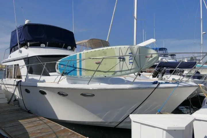 Slide: The Image of 1986 Ocean Alexander 39 Sedan cruising in a harbor with industrial background. - 80