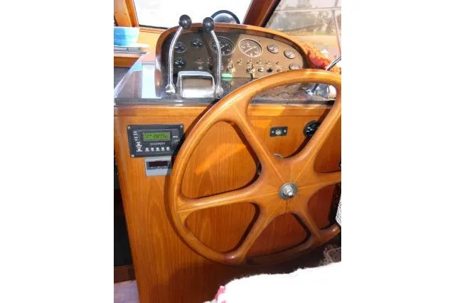 Slide: The Image of 1986 Ocean Alexander 39 Sedan helm with wooden steering wheel and control panel. - 9