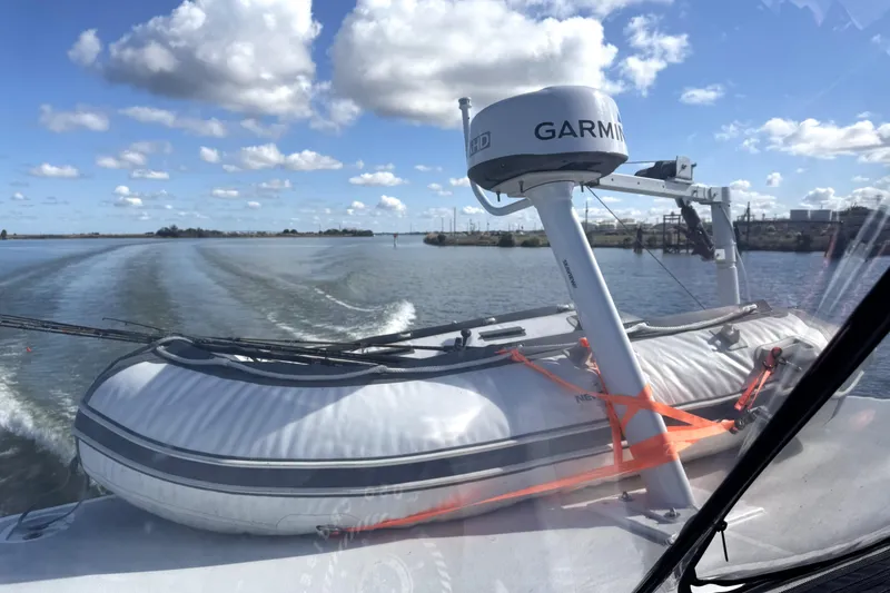 Slide: The Image of 1999 Silverton 422 Motor Yacht with Garmin radar and inflatable boat on deck. - 13