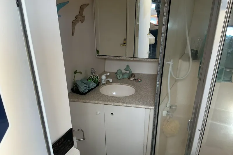 Slide: The Image of Bathroom interior of 1999 Silverton 422 Motor Yacht with sink and shower. - 16