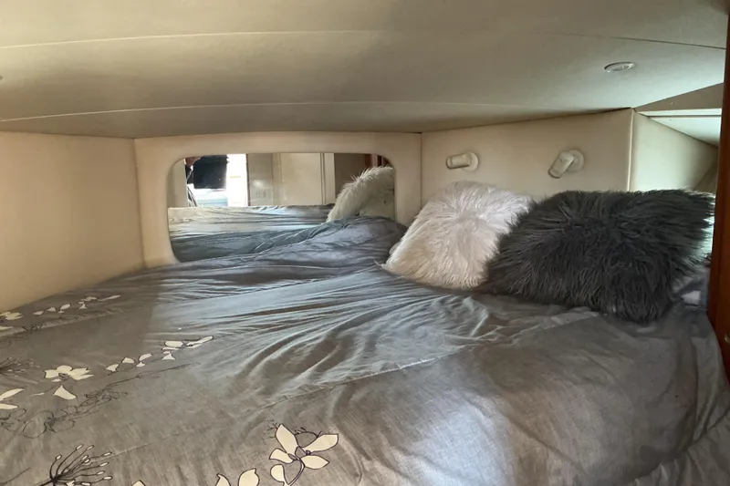 Slide: The Image of Cozy bedroom in 1999 Silverton 422 Motor Yacht with plush pillows and floral bedding. - 17