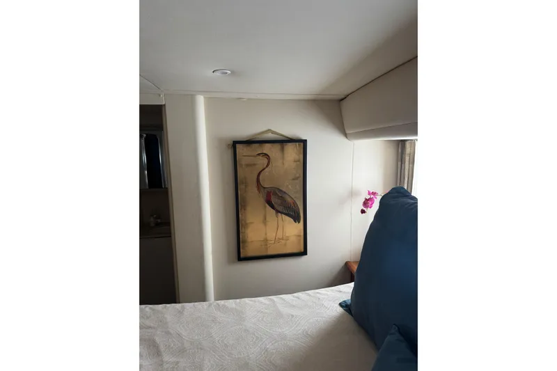 Slide: The Image of Interior of 1999 Silverton 422 Motor Yacht with elegant bird artwork and floral decor. - 19