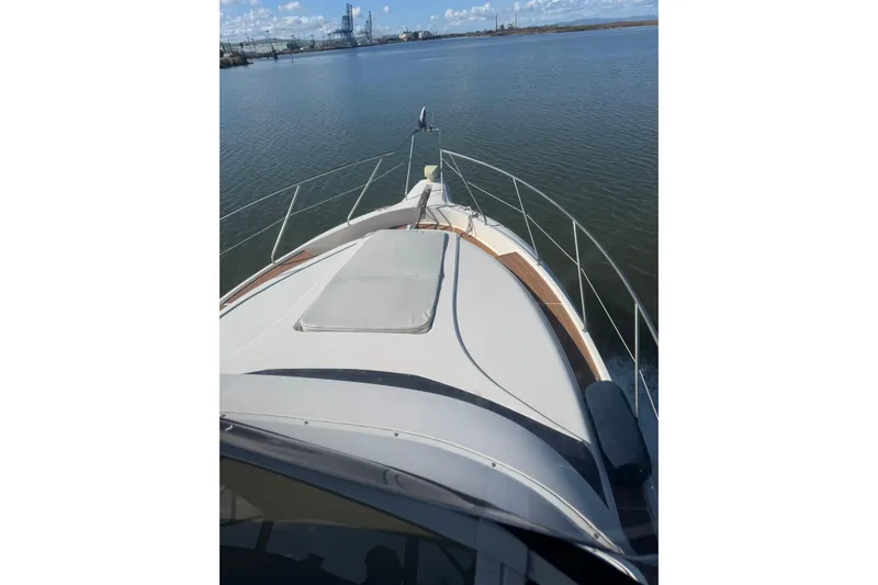 Slide: The Image of 1999 Silverton 422 Motor Yacht cruising on calm waters under a clear sky. - 20
