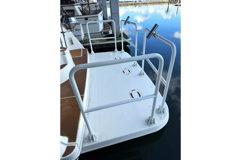 Slide: The Image of 1999 Silverton 422 Motor Yacht swim platform with railings and rod holders. - 21