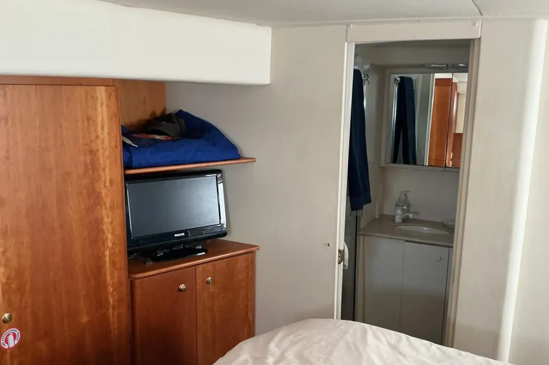 Slide: The Image of Interior of 1999 Silverton 422 Motor Yacht with TV and bathroom view. - 6