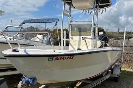 Slide: The Image of 1992 Key West 1900 Sportsman boat on trailer, featuring a center console and canopy. - 3