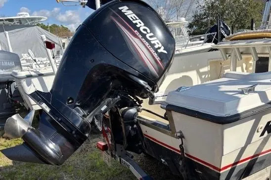 Slide: The Image of 1992 Key West 1900 Sportsman boat with Mercury outboard motor, docked outdoors. - 4