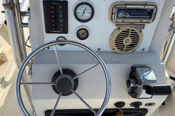 Slide: The Image of 1992 Key West 1900 Sportsman boat dashboard with steering wheel and control panel. - 6