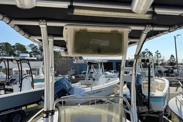 Slide: The Image of 1992 Key West 1900 Sportsman boat with T-top, surrounded by other boats in a marina. - 8