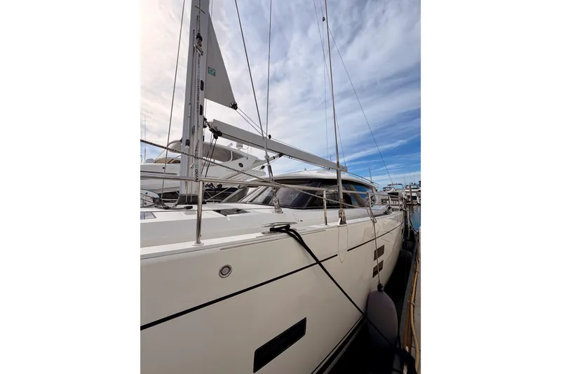 Slide: The Image of 2016 Moody Decksaloon 54 yacht docked under a partly cloudy sky. - 10
