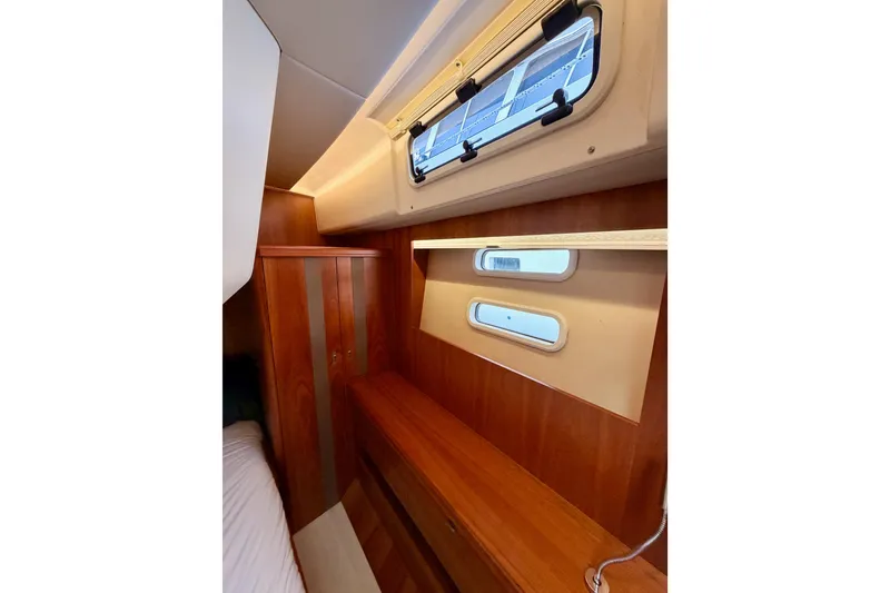 Slide: The Image of Interior cabin of 2016 Moody Decksaloon 54 yacht with wooden finish and porthole windows. - 103