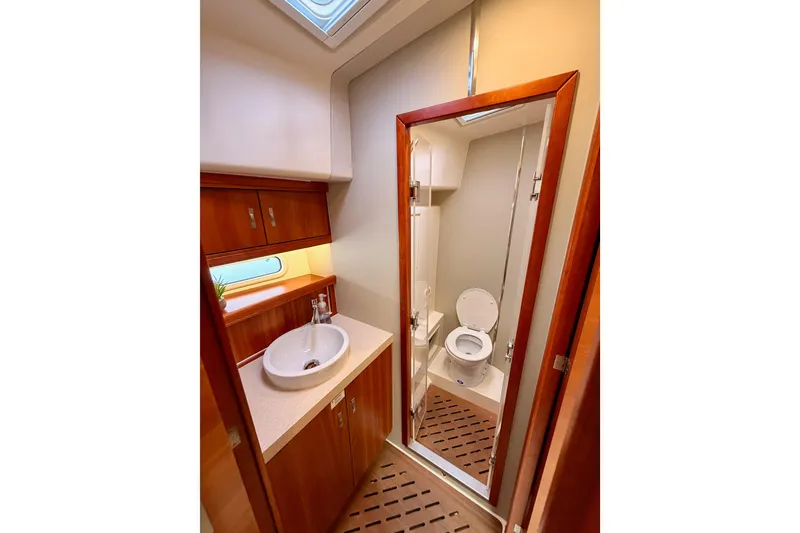 Slide: The Image of Luxurious bathroom in 2016 Moody Decksaloon 54 yacht with modern fixtures and wooden accents. - 105