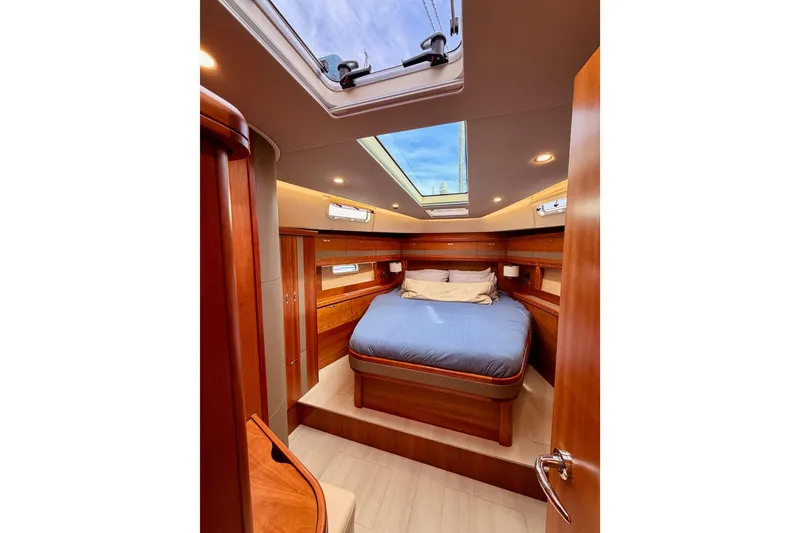 Slide: The Image of Luxurious cabin interior of 2016 Moody Decksaloon 54 yacht with skylight and wooden finish. - 108