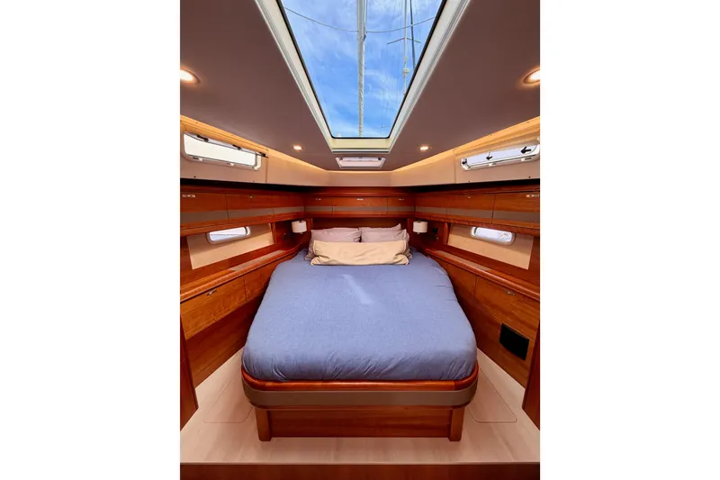 Slide: The Image of Luxurious cabin interior of 2016 Moody Decksaloon 54 yacht with skylight and wooden finish. - 110
