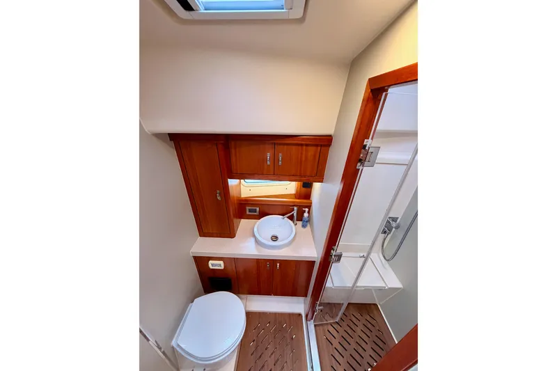 Slide: The Image of Luxurious bathroom in 2016 Moody Decksaloon 54 yacht with wood accents and modern fixtures. - 115