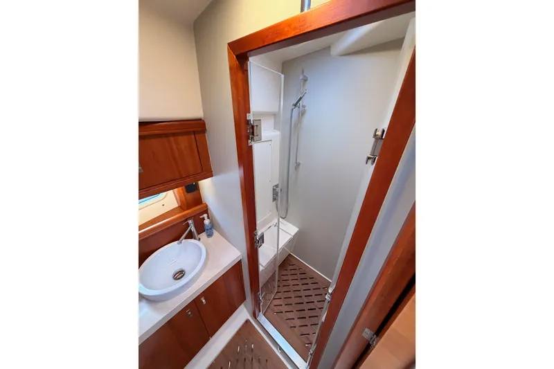 Slide: The Image of Luxurious bathroom in 2016 Moody Decksaloon 54 yacht with wooden accents and modern fixtures. - 116
