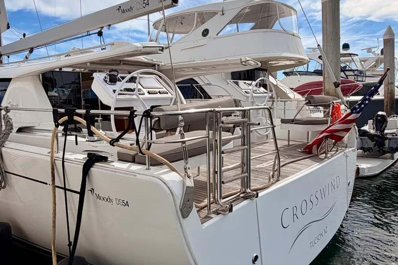 Slide: The Image of Luxury 2016 Moody Decksaloon 54 yacht docked at marina with American flag. - 12