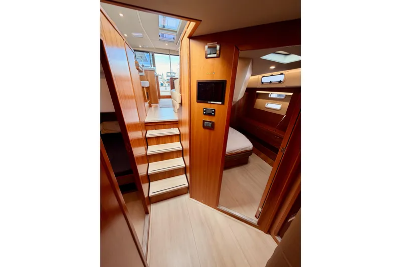 Slide: The Image of Interior of 2016 Moody Decksaloon 54 yacht with wooden stairs and cozy cabin. - 121