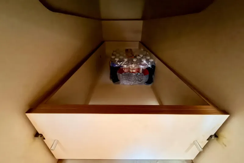 Slide: The Image of Storage compartment in 2016 Moody Decksaloon 54 yacht with bottled water. - 123