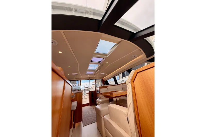 Slide: The Image of Luxurious interior of 2016 Moody Decksaloon 54 yacht with skylights and elegant seating. - 124