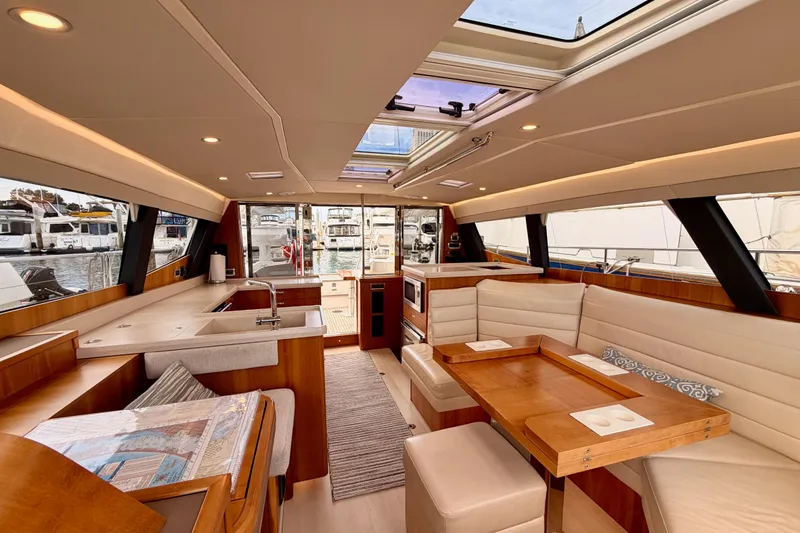 Slide: The Image of Luxurious interior of 2016 Moody Decksaloon 54 yacht with modern kitchen and seating area. - 125
