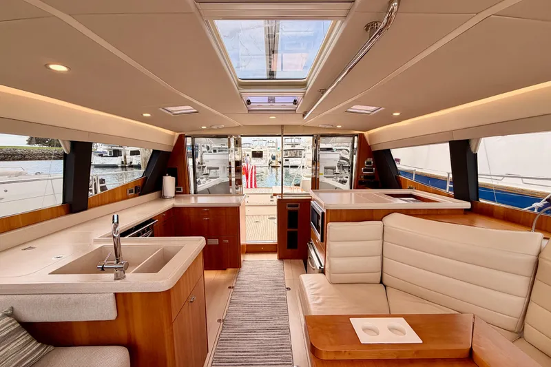Slide: The Image of Luxurious interior of 2016 Moody Decksaloon 54 yacht with modern kitchen and seating area. - 126