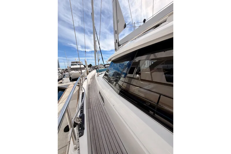 Slide: The Image of 2016 Moody Decksaloon 54 yacht docked, showcasing sleek design and polished deck. - 17