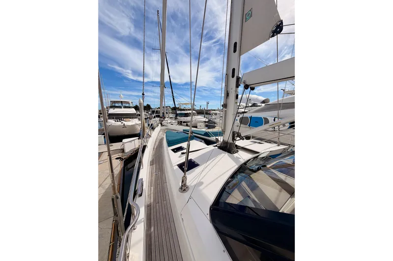 Slide: The Image of Sailing yacht Moody Decksaloon 54, 2016 model, docked at marina under blue sky. - 18