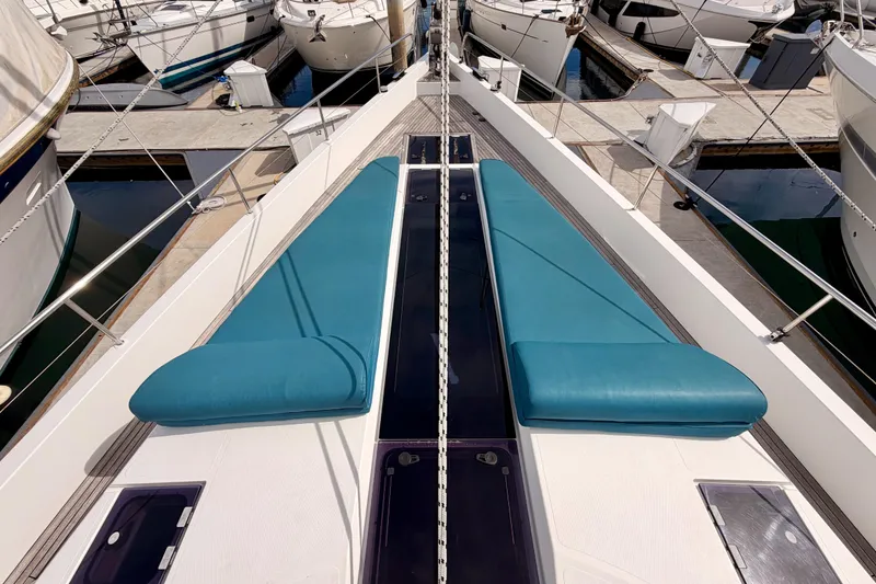 Slide: The Image of Moody Decksaloon 54 yacht deck with blue cushions, docked in a marina, 2016 model. - 20