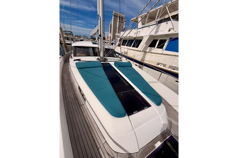 Slide: The Image of Moody Decksaloon 54 yacht, 2016 model, docked with sleek design and teal sunbathing pads. - 29