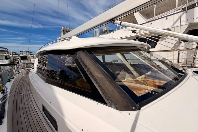 Slide: The Image of 2016 Moody Decksaloon 54 yacht docked, showcasing sleek design and spacious deck. - 32