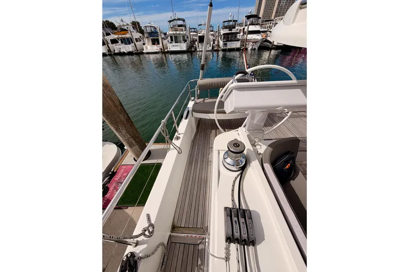 Slide: The Image of 2016 Moody Decksaloon 54 yacht deck with marina view, featuring modern sailing equipment. - 34