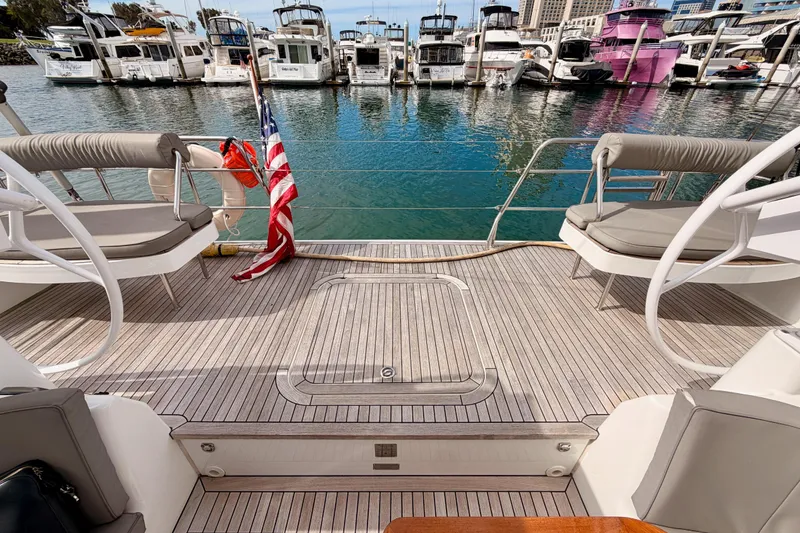 Slide: The Image of Luxury yacht deck of 2016 Moody Decksaloon 54, with marina view and American flag. - 36
