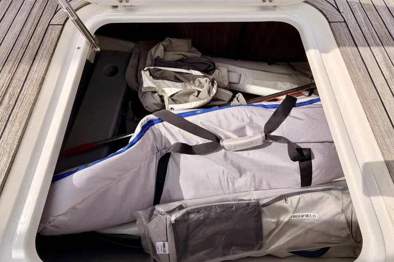 Slide: The Image of Storage compartment on a 2016 Moody Decksaloon 54 yacht with various bags and equipment. - 37