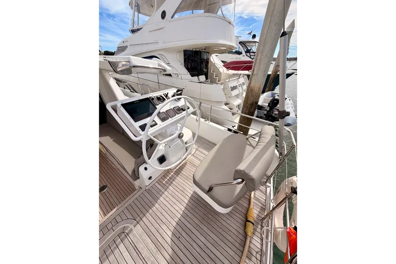 Slide: The Image of Helm of 2016 Moody Decksaloon 54 yacht with modern controls and seating. - 38